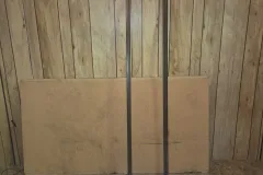 The bed rails and support board leaning against a wall