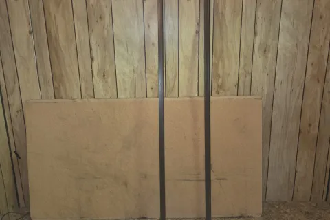 The bed rails and support board leaning against a wall