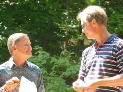 Graham and Jack speaking to each other at the AGM
