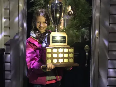 Sophia Edey holding the youth fishing trophy