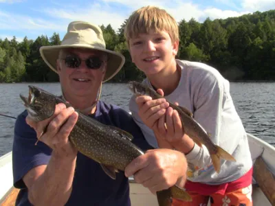Jim and Leandro holding fish in their hands