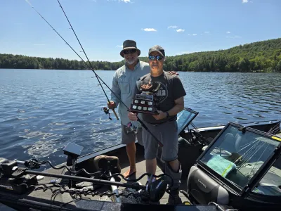 2026 bass tournament winners with the trophy in their boat