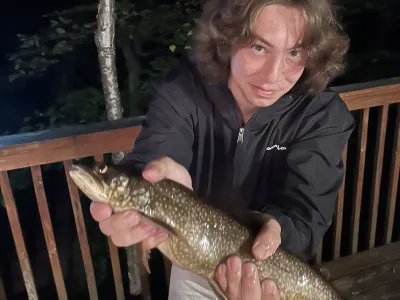 Julian Tilman holds up a Lake Trout that he caught.