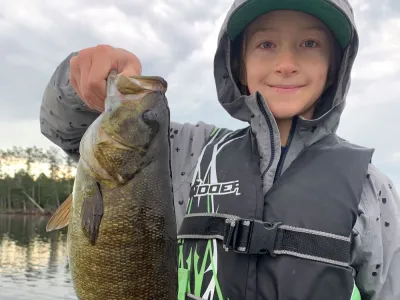 Marcello Richert holds up an 18 inch bass while on a boat on Percy Lake.