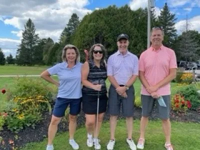 Team #3 and a team of four pose at the Lakeside Golf Course.
