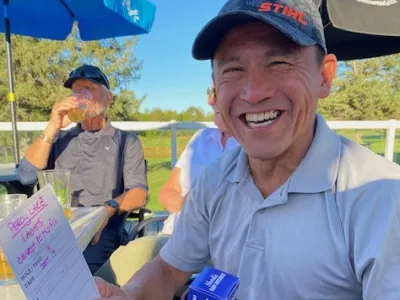 Bob Wong, shortest drive, laughing with his scorecard