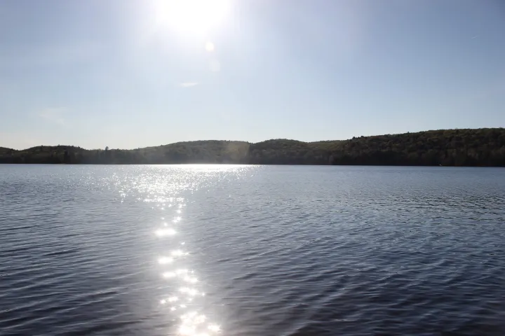 The sun leaves a line of shining water across Percy Lake.